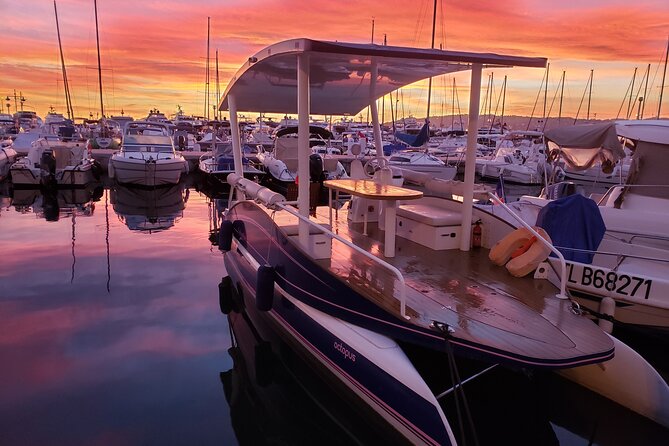 Private Sunset Cruise in Juan les Pins - Stop 3: Juan-les-Pins bay at golden hour, with Alps and islands in the frame